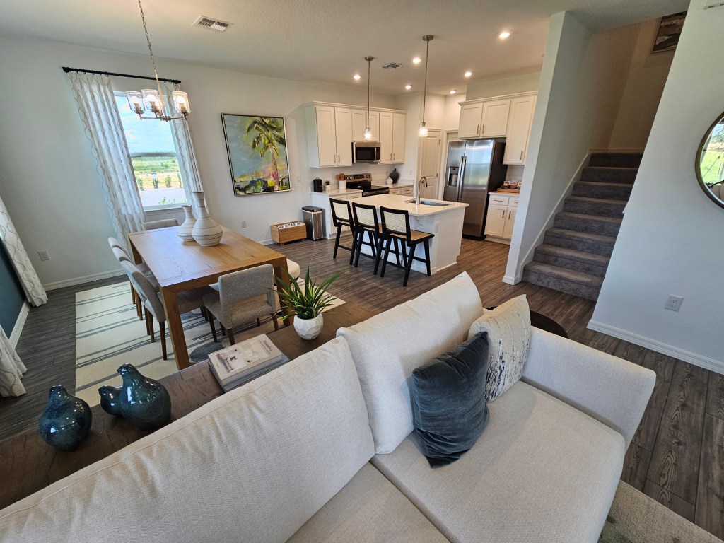 Beautiful common room with luxury vinyl plank flooring and quartz counter tops. Located at Wynnstone in Davenport Florida. Rich Noto is the best Realtor for new construction homes like this one.